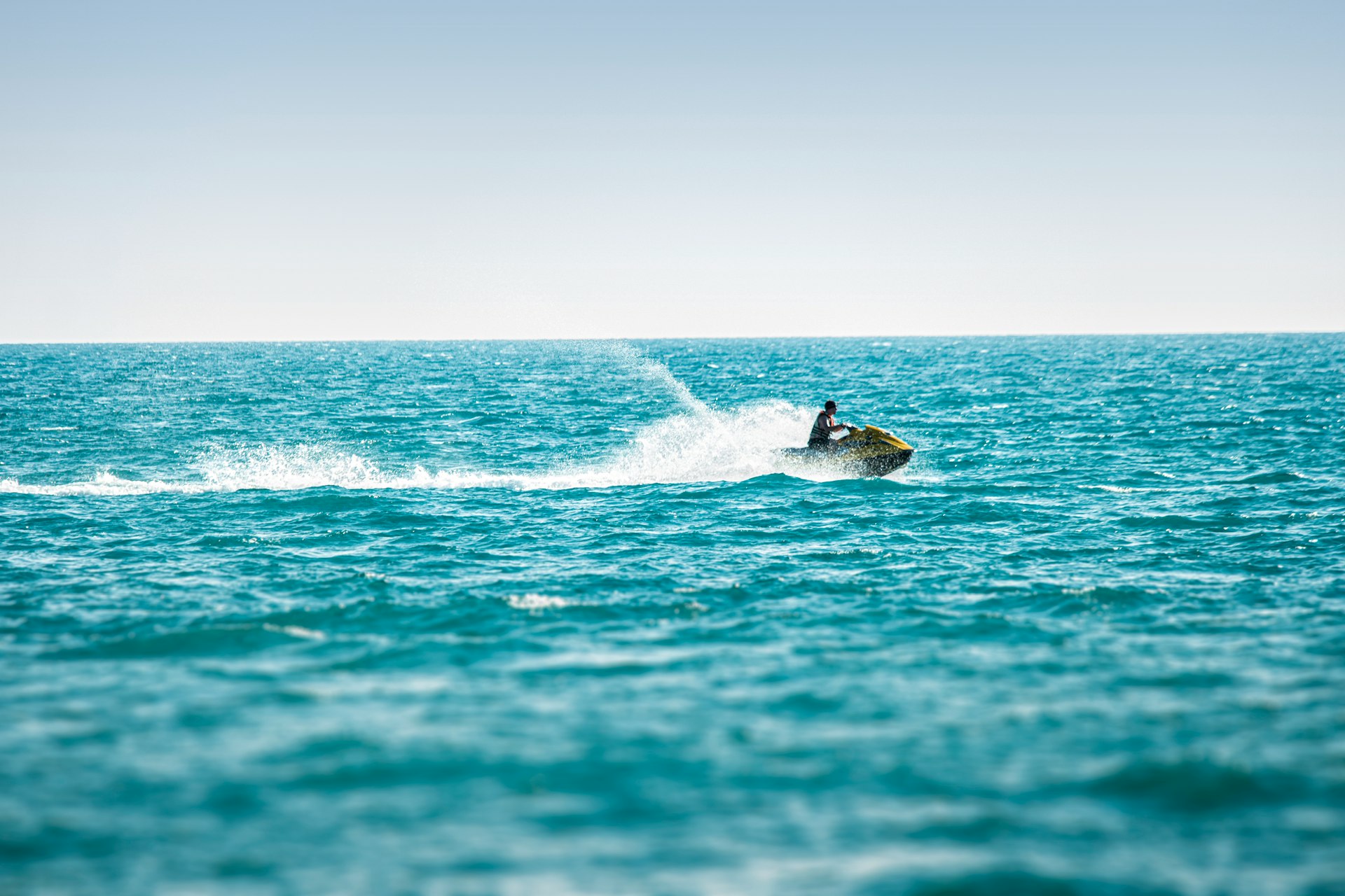man surfing on sea waves during daytime